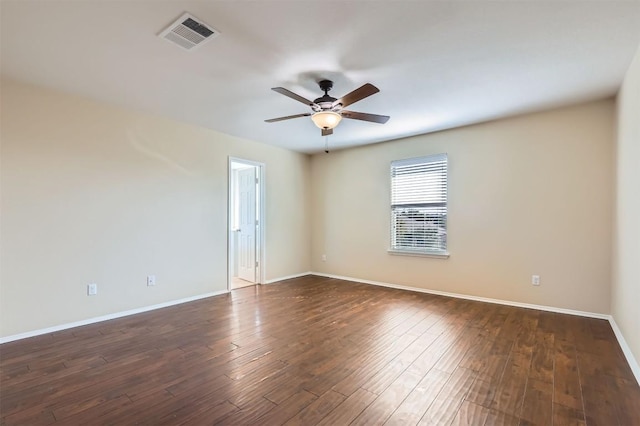 spare room featuring dark hardwood / wood-style floors and ceiling fan