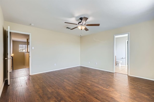 empty room with dark hardwood / wood-style floors and ceiling fan