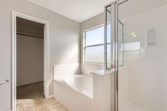 bathroom featuring tile patterned flooring and separate shower and tub