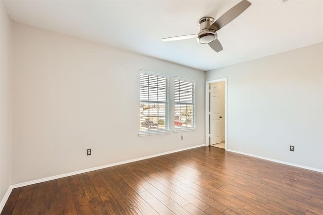 spare room featuring ceiling fan and dark wood-type flooring