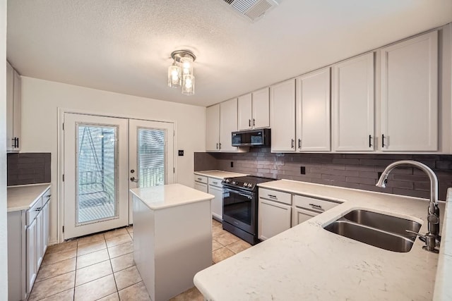 kitchen featuring white cabinetry, french doors, sink, tasteful backsplash, and black electric range