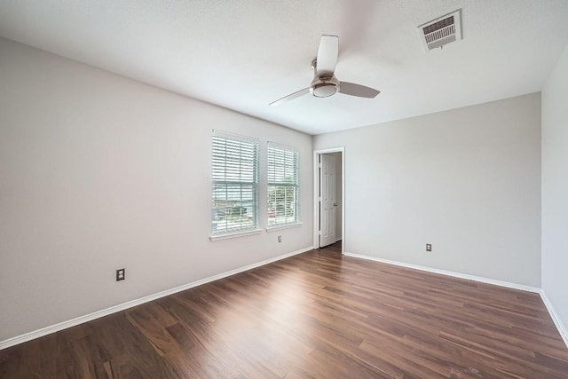 unfurnished room with ceiling fan and dark hardwood / wood-style flooring