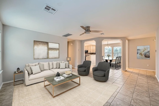 tiled living room featuring ceiling fan