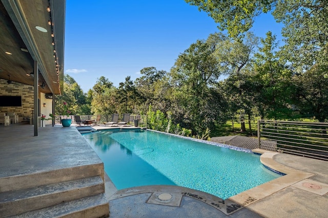 view of swimming pool with a patio area