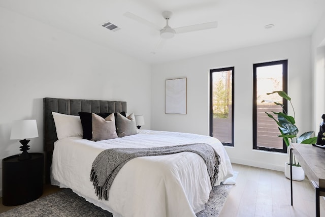 bedroom with light hardwood / wood-style floors and ceiling fan