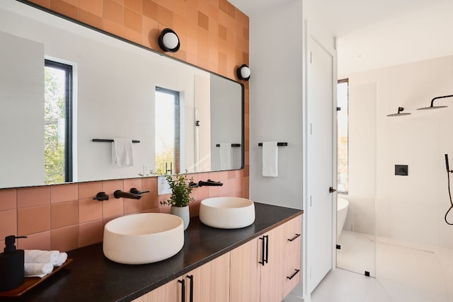 bathroom featuring tile patterned floors, vanity, tile walls, and tasteful backsplash