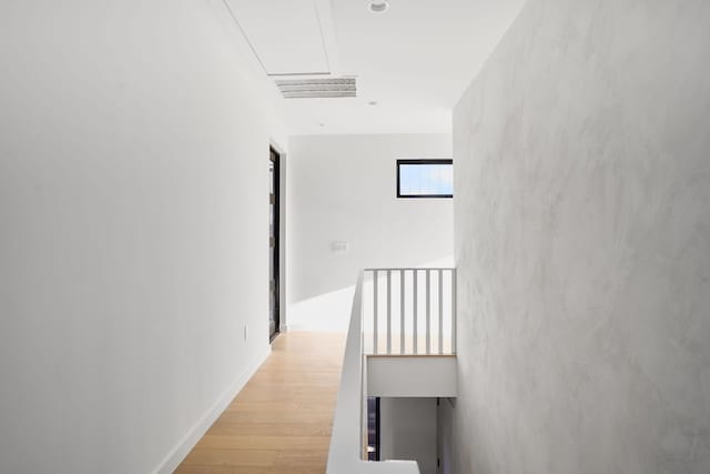 corridor with light hardwood / wood-style floors