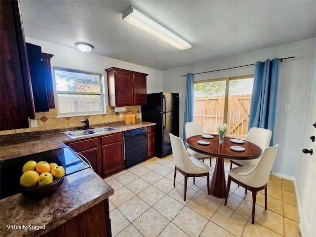 kitchen featuring light tile patterned floors, sink, plenty of natural light, and black appliances