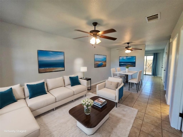 tiled living room featuring ceiling fan