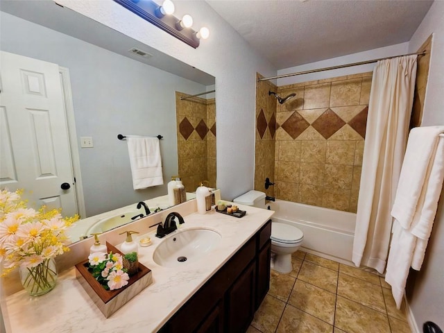 full bathroom with shower / bath combo, vanity, tile patterned floors, toilet, and a textured ceiling