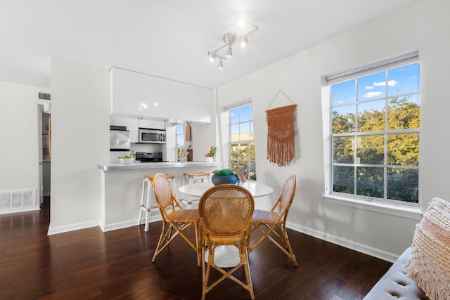 dining room with dark wood-type flooring