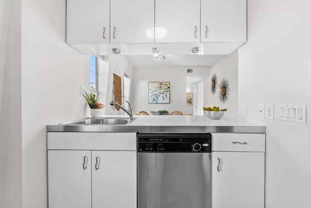 kitchen with dishwasher, white cabinets, and sink