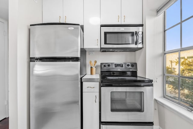 kitchen featuring appliances with stainless steel finishes and white cabinetry