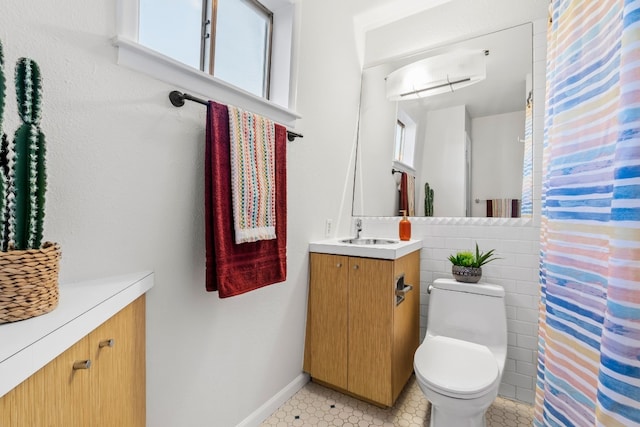 bathroom with vanity, toilet, and a wealth of natural light