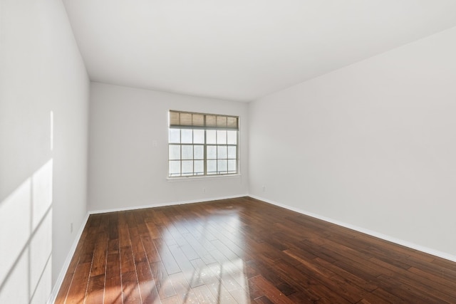 spare room featuring dark hardwood / wood-style flooring