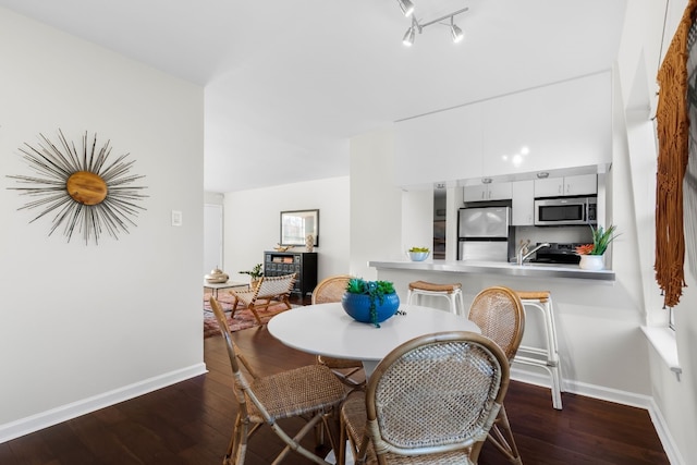 dining area with dark hardwood / wood-style floors