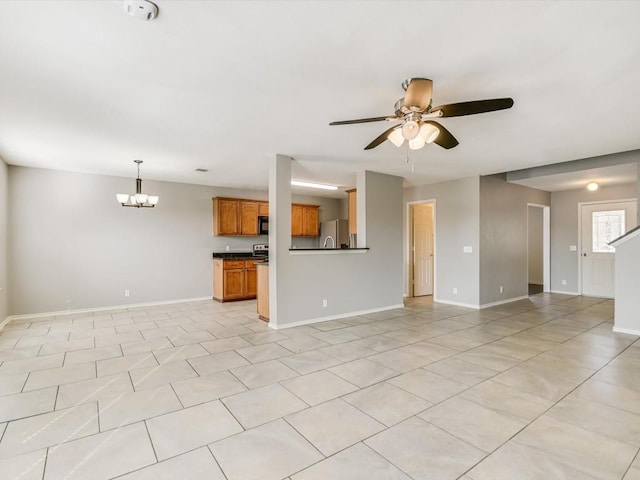 unfurnished living room featuring ceiling fan with notable chandelier and light tile patterned floors