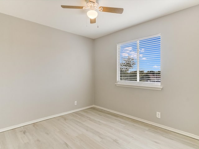 empty room with ceiling fan and light hardwood / wood-style floors