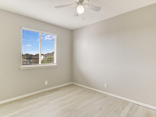 spare room with light hardwood / wood-style floors and ceiling fan