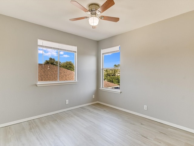 spare room with light wood-type flooring and ceiling fan