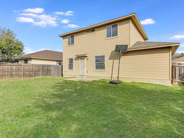 back of property featuring a lawn