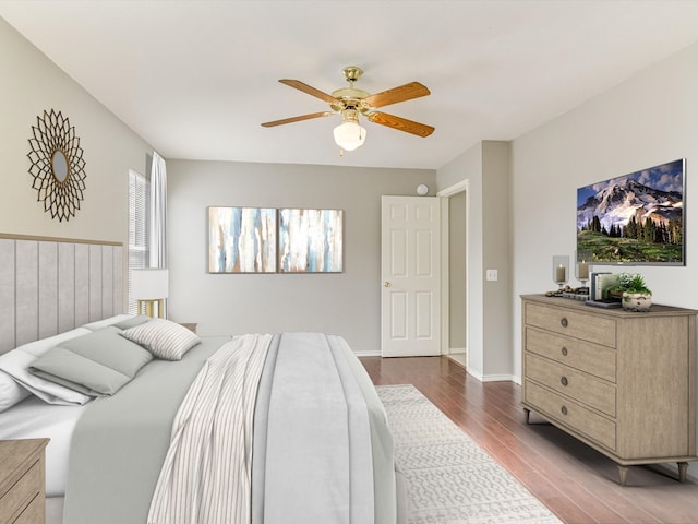 bedroom with baseboards, a ceiling fan, and wood finished floors