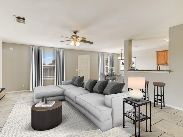 tiled living room with ceiling fan with notable chandelier