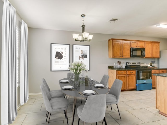 tiled dining area with an inviting chandelier