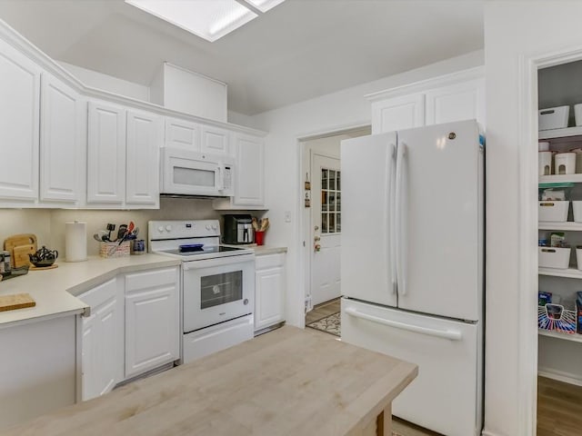 kitchen with white appliances and white cabinets