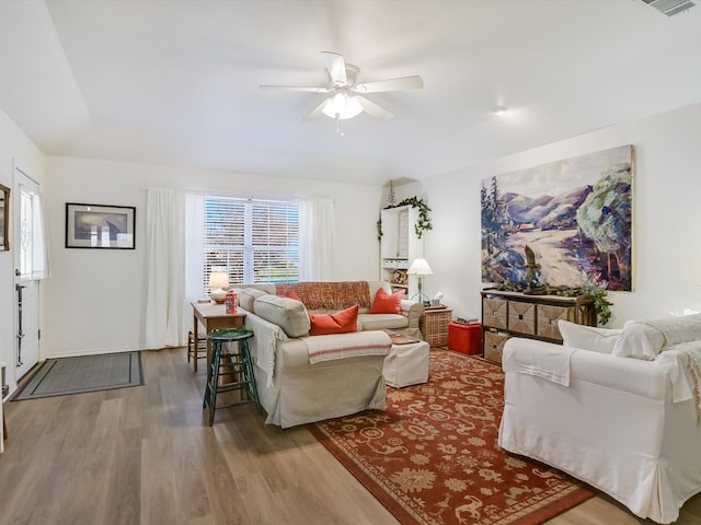 living room featuring hardwood / wood-style flooring and ceiling fan