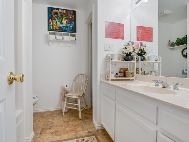 bathroom with toilet and vanity