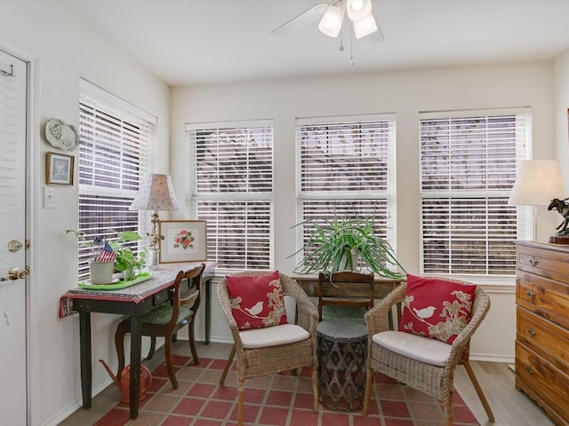 living area with hardwood / wood-style floors and ceiling fan