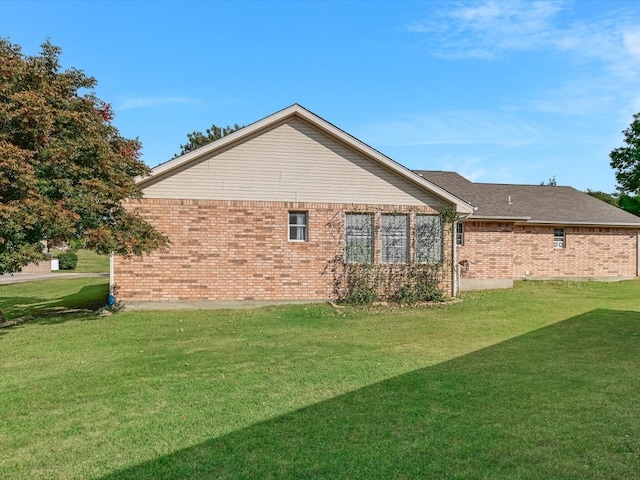 view of side of home with a lawn