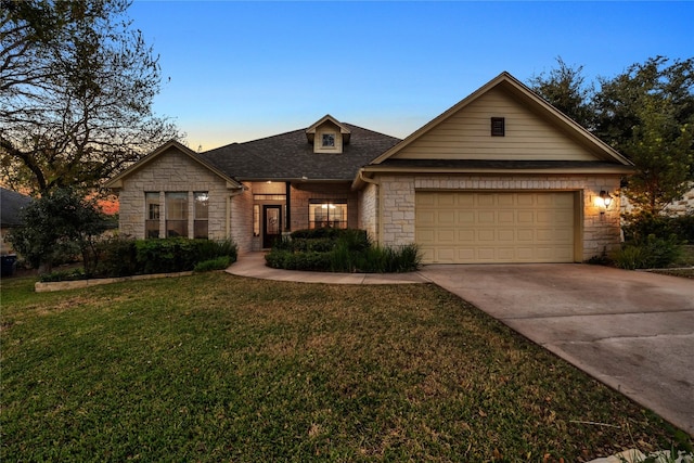 view of front of house featuring a lawn and a garage