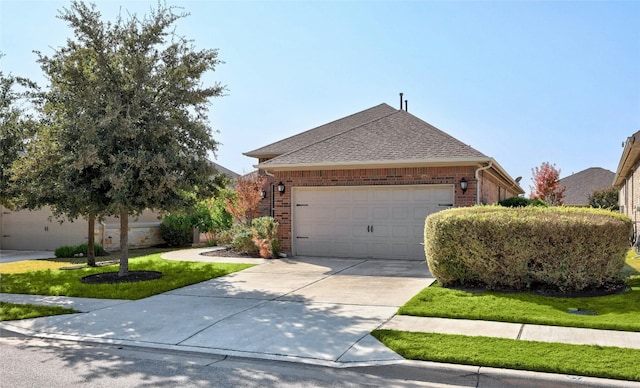 ranch-style home featuring a front yard and a garage