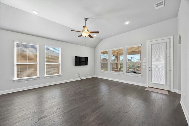 unfurnished living room featuring dark hardwood / wood-style flooring, a wealth of natural light, lofted ceiling, and ceiling fan