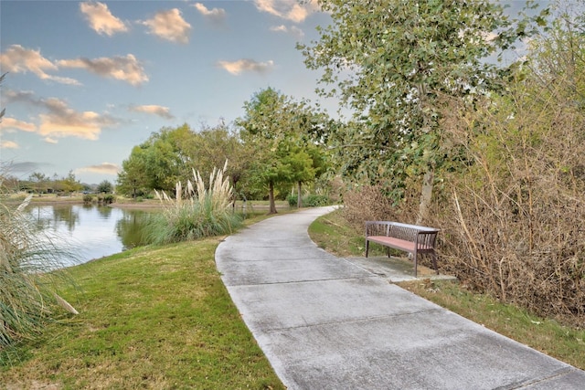 view of property's community featuring a yard and a water view