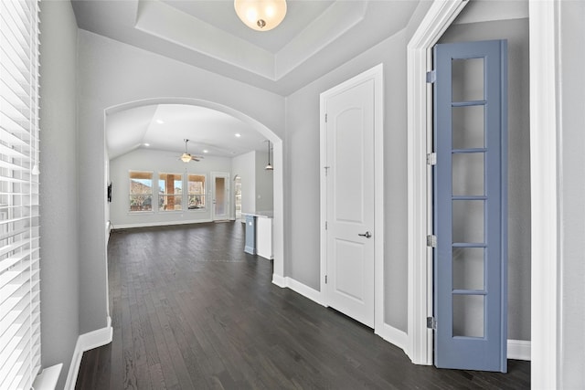 corridor featuring dark hardwood / wood-style floors and lofted ceiling