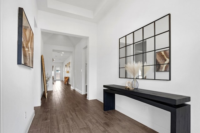 hall featuring baseboards and wood finished floors