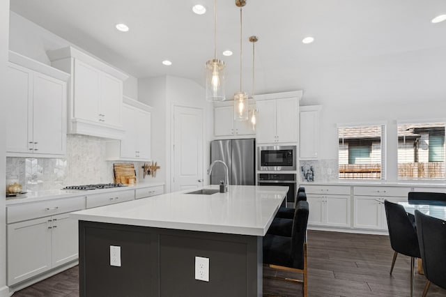 kitchen with built in microwave, a sink, freestanding refrigerator, recessed lighting, and oven