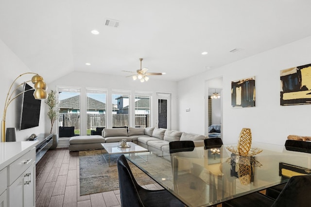 dining area featuring ceiling fan, dark wood-type flooring, and vaulted ceiling