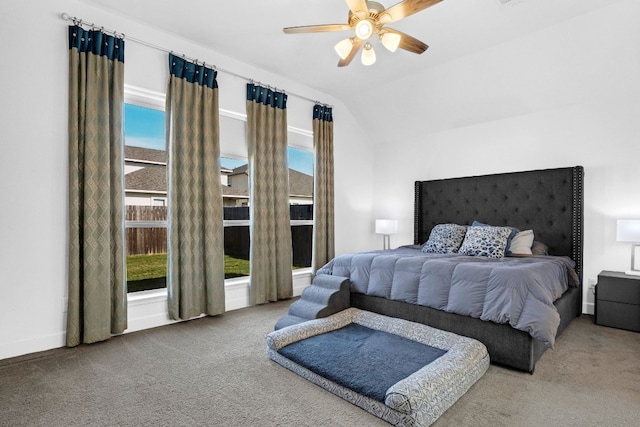 bedroom with ceiling fan, carpet floors, and lofted ceiling