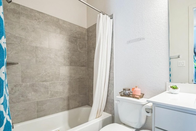 bathroom with toilet, a textured wall, shower / bath combination with curtain, and vanity