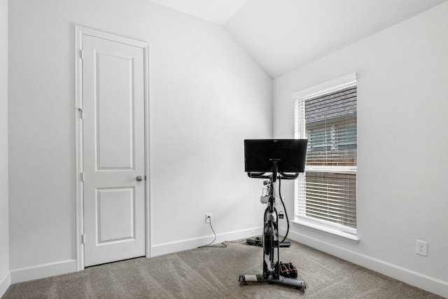 workout room featuring baseboards, vaulted ceiling, and carpet flooring