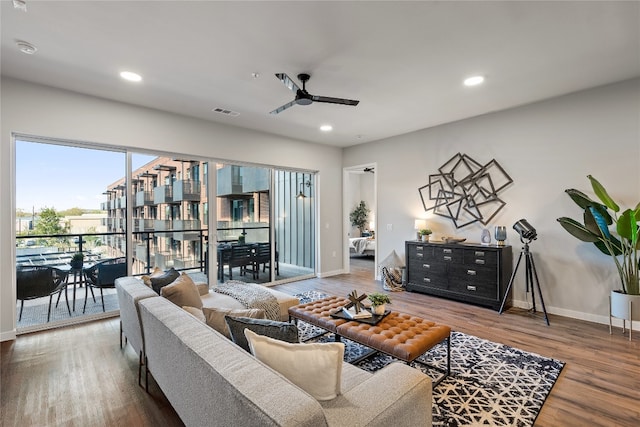 living room with hardwood / wood-style floors and ceiling fan