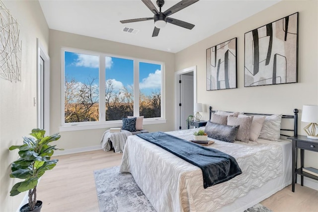 bedroom with ceiling fan and light hardwood / wood-style floors