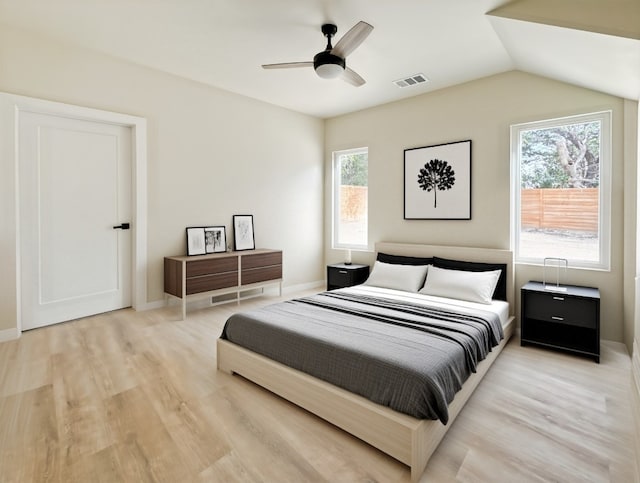 bedroom featuring vaulted ceiling, light hardwood / wood-style flooring, and ceiling fan