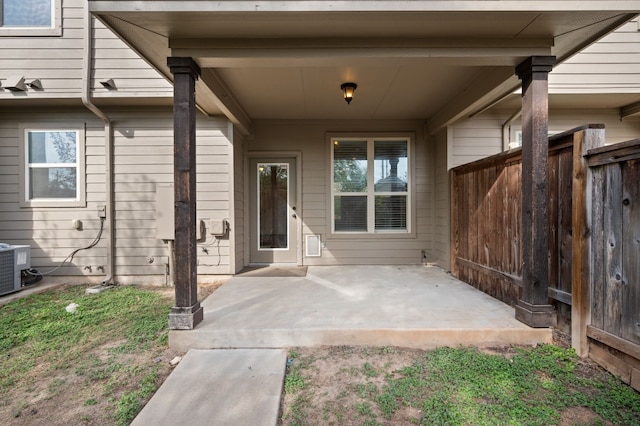 property entrance featuring cooling unit and a patio