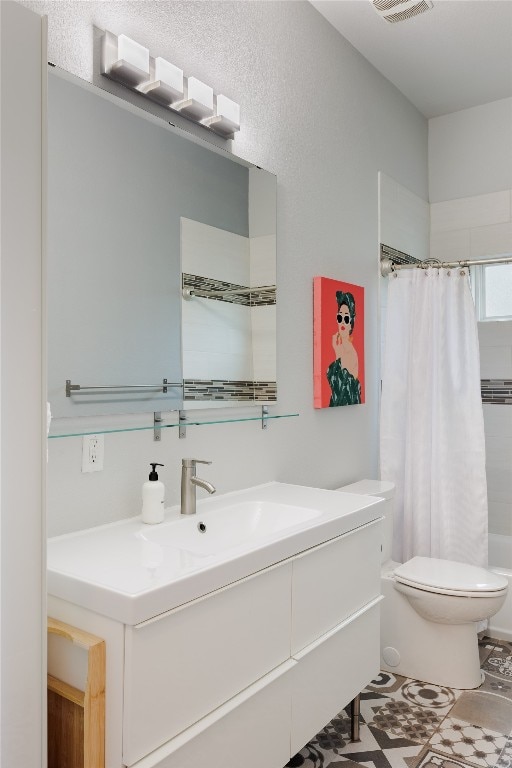 bathroom featuring tile patterned floors, vanity, and toilet