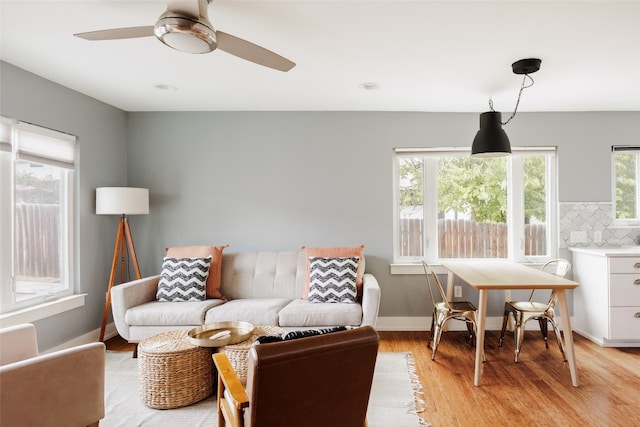 living room featuring ceiling fan and light hardwood / wood-style floors